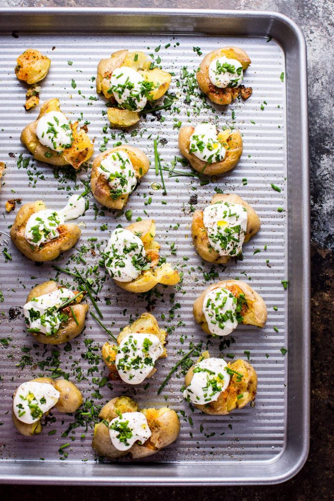 baking tray with lemon and garlic smashed potatoes