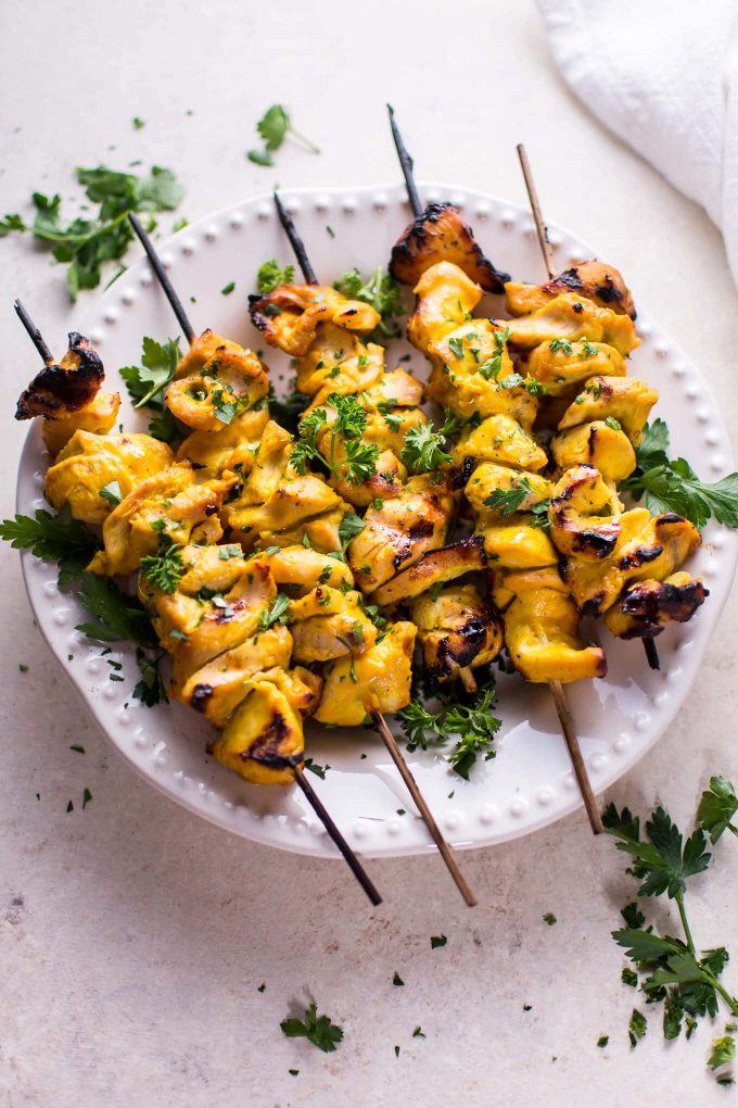 plate of BBQ honey mustard chicken skewers with parsley garnish