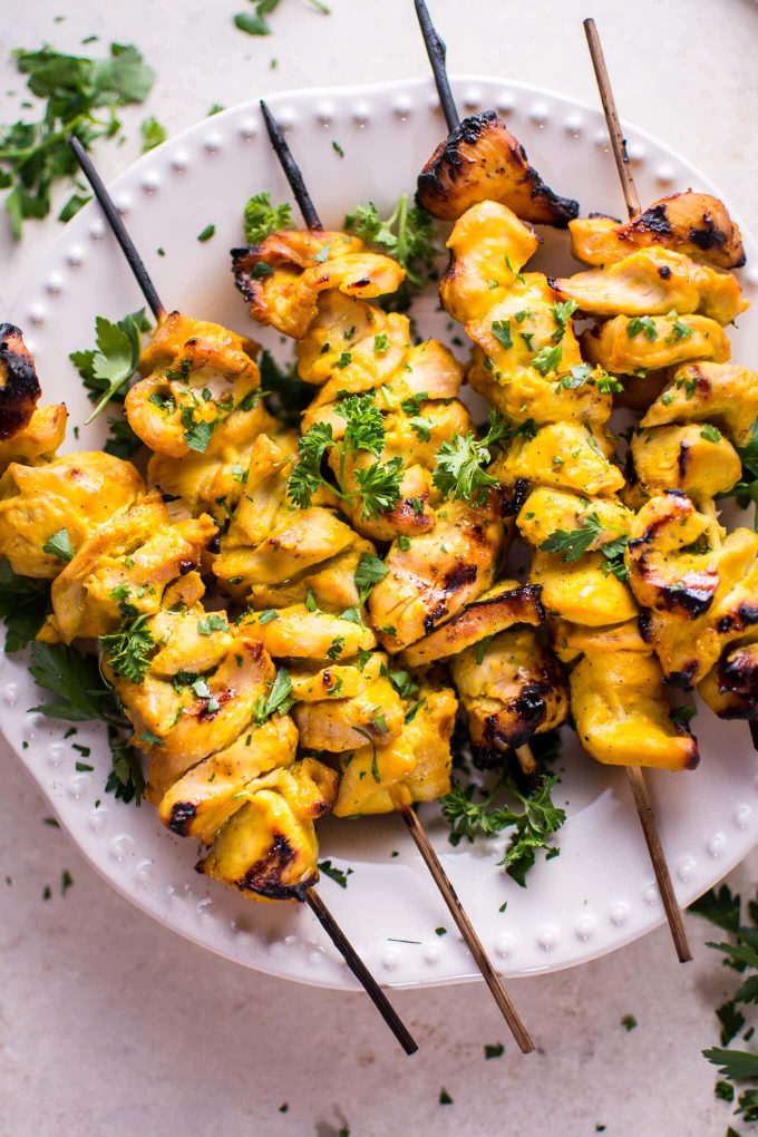 several grilled honey mustard chicken skewers on a plate