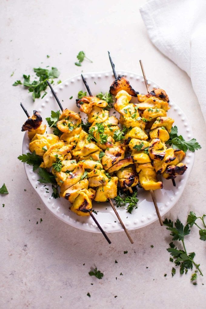 plate with five grilled honey mustard BBQ chicken skewers