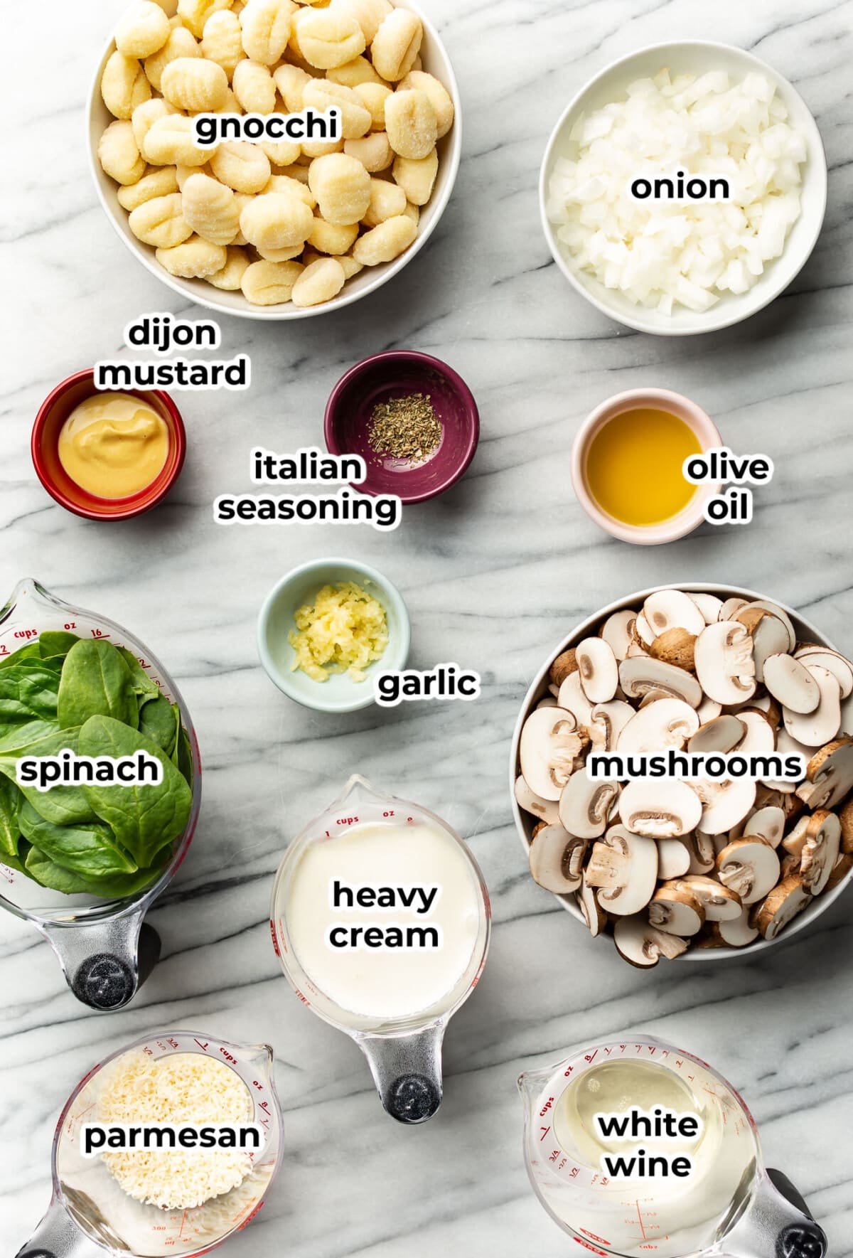 ingredients for creamy mushroom spinach gnocchi in prep bowls