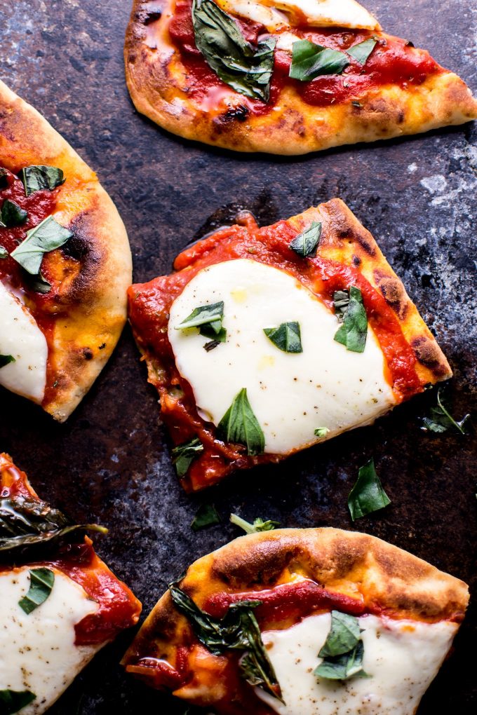close-up of mozzarella, tomato, and basil naan pizza