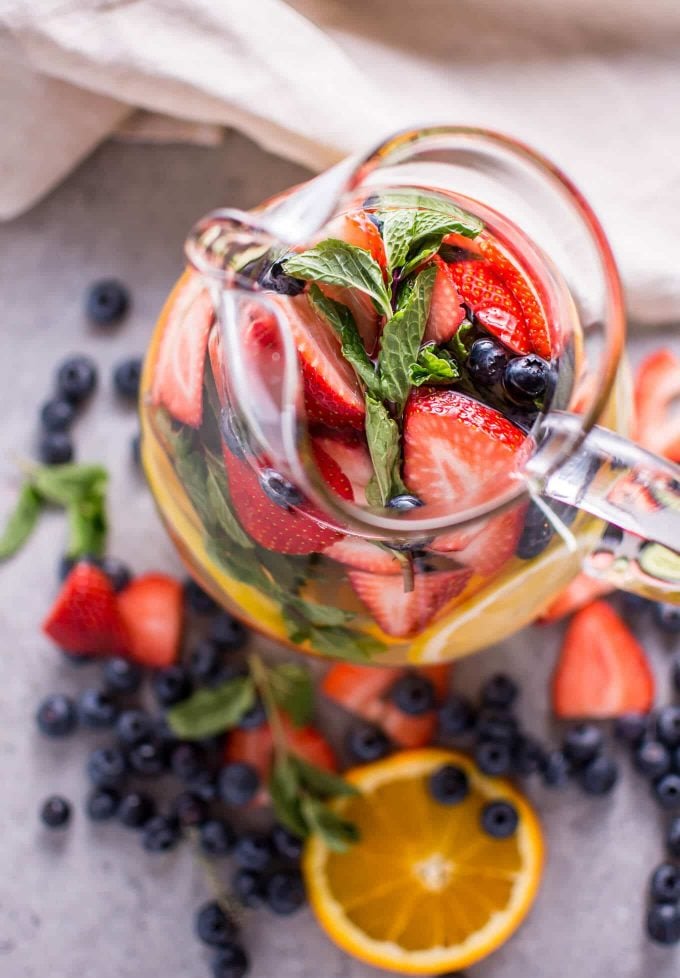 close-up of pitcher of rainbow fruit infused water