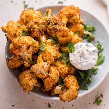 These roasted cauliflower bites with a mint dip are a tasty vegetarian appetizer or side dish! Ready in 30 minutes.