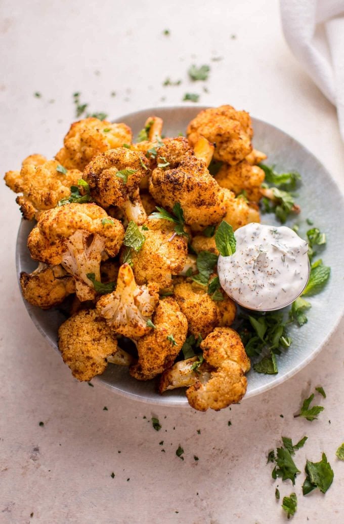 bowl of vegetarian roasted cauliflower bites with mint dip