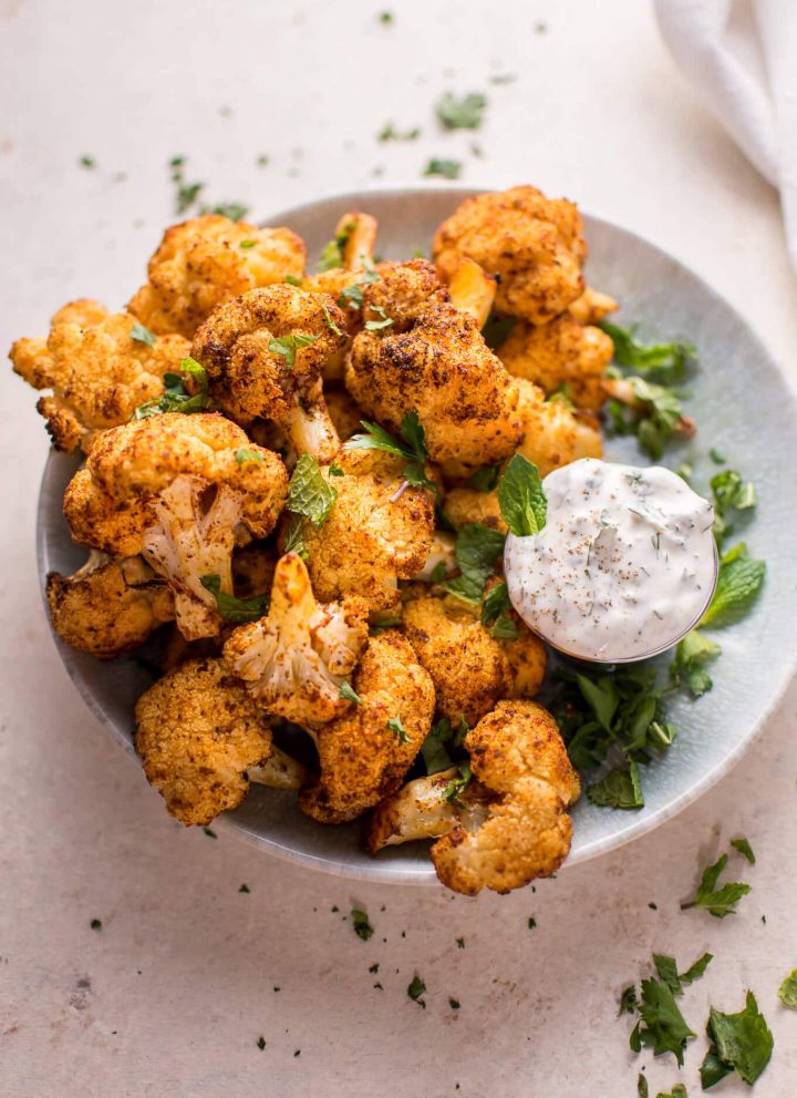 These roasted cauliflower bites with a mint dip are a tasty vegetarian appetizer or side dish! Ready in 30 minutes.