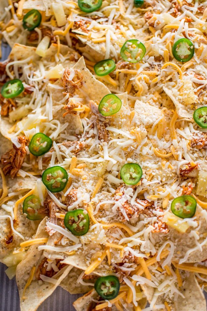 close-up of tropical chicken nachos with plenty of cheese
