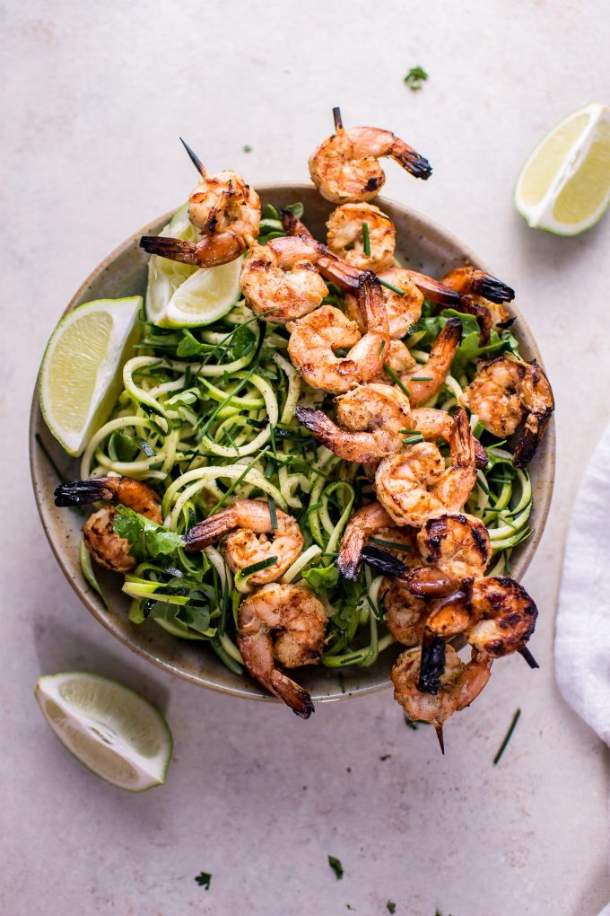 bowl with low-carb grilled chili lime shrimp zoodles and lime wedges