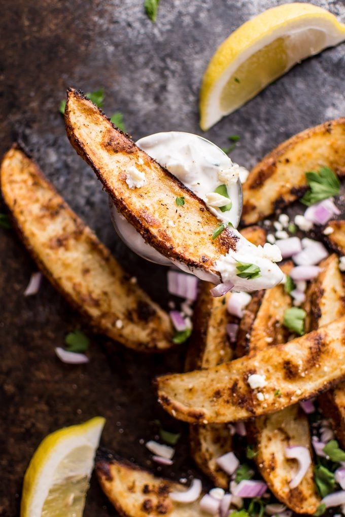 Greek loaded baked potato wedges with tzatziki dipping sauce