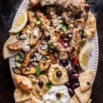 The Ultimate Greek Chicken Souvlaki Platter is loaded with tender grilled chicken skewers, pita bread, Greek potato wedges, hummus, tzatziki, melitzanosalata, kalamata olives, feta, and other goodies. The perfect meze assortment for any feast or party!