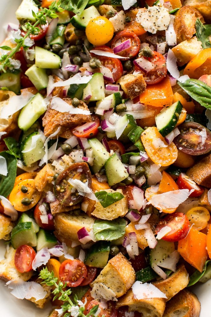 close-up of cucumbers, tomatoes, basil, and bread in Italian panzanella salad