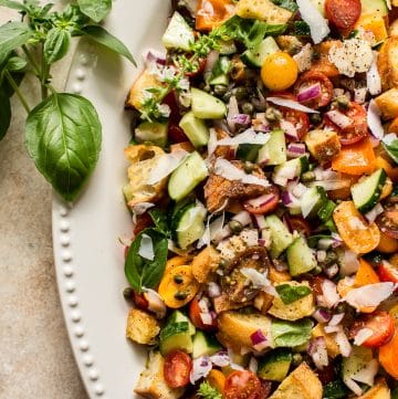 This panzanella salad recipe is a healthy and delicious traditional Italian vegetarian summer meal with a tangy vinaigrette dresing. Perfect for summer gatherings, parties, and BBQs. 