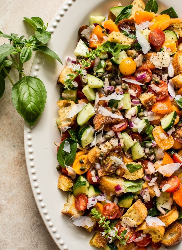 This panzanella salad recipe is a healthy and delicious traditional Italian vegetarian summer meal with a tangy vinaigrette dresing. Perfect for summer gatherings, parties, and BBQs. 