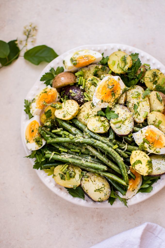 potato and green bean egg salad on a white plate