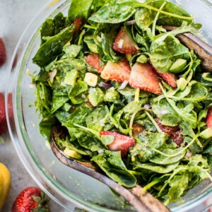 This strawberry spinach salad with mango dressing is a fresh and fruity salad that will be on repeat all summer long! Creamy avocado, peppery arugula, and red onions add a wonderful contrast to the sweet strawberries.