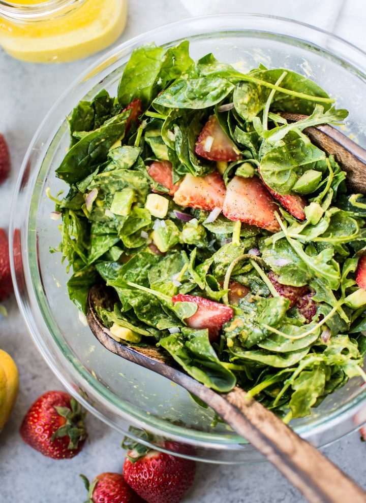This strawberry spinach salad with mango dressing is a fresh and fruity salad that will be on repeat all summer long! Creamy avocado, peppery arugula, and red onions add a wonderful contrast to the sweet strawberries.