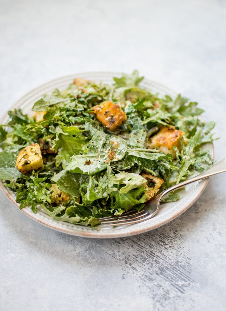 This baby kale salad is an easy and fast way to enjoy kale. The lemon tahini dressing and garlicky parmesan croutons make this a wonderfully flavorful salad!