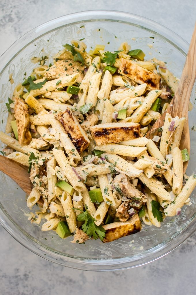 healthy grilled chicken pasta salad in a glass bowl close-up