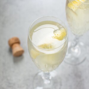 This lemon champagne cocktail is lively, refreshing, and perfect for summer. Lemon simple syrup adds just the right amount of sweetness and lemon flavor to this bubbly drink.