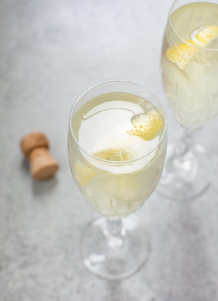 This lemon champagne cocktail is lively, refreshing, and perfect for summer. Lemon simple syrup adds just the right amount of sweetness and lemon flavor to this bubbly drink.