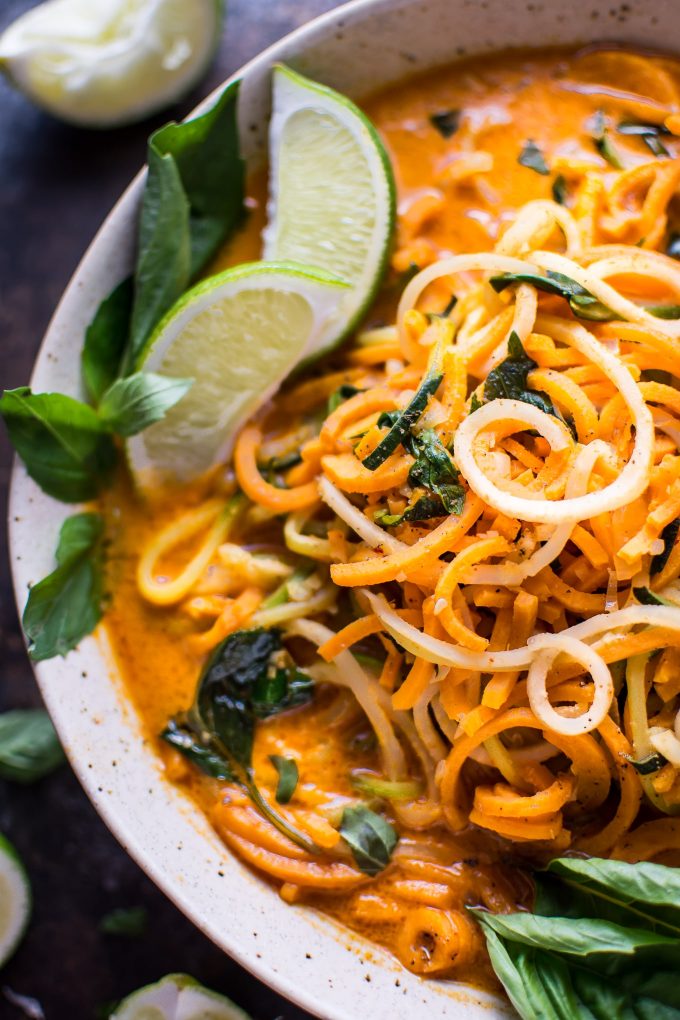 close-up of spiralized Thai coconut curry soup with lime wedges