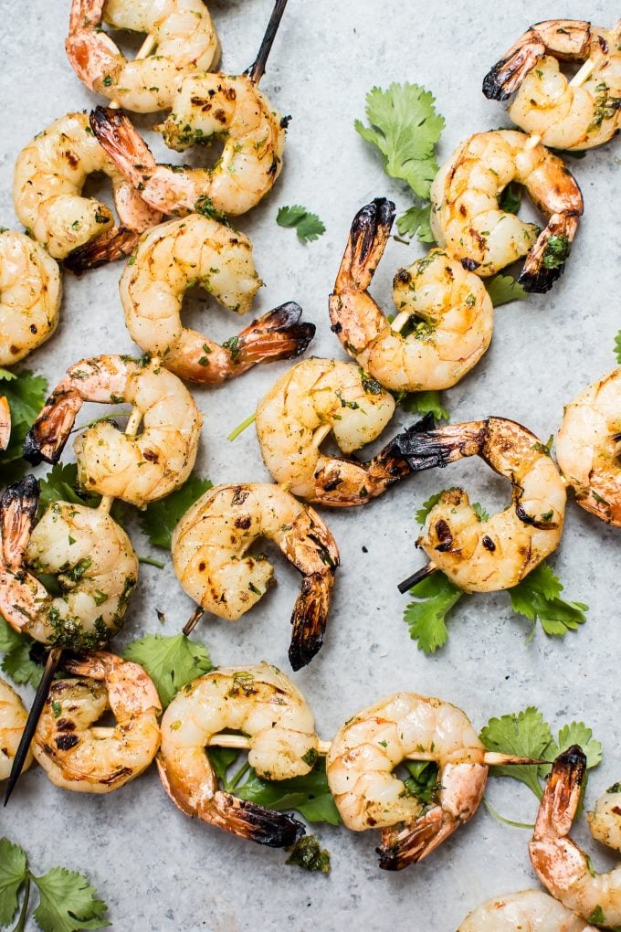 several grilled tequila lime shrimp on wooden skewers