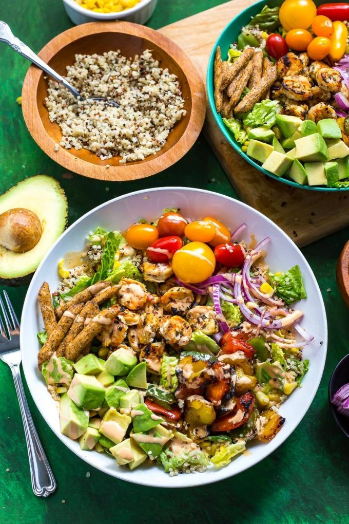 fiesta grilled shrimp salad with avocado and tomatoes in a bowl