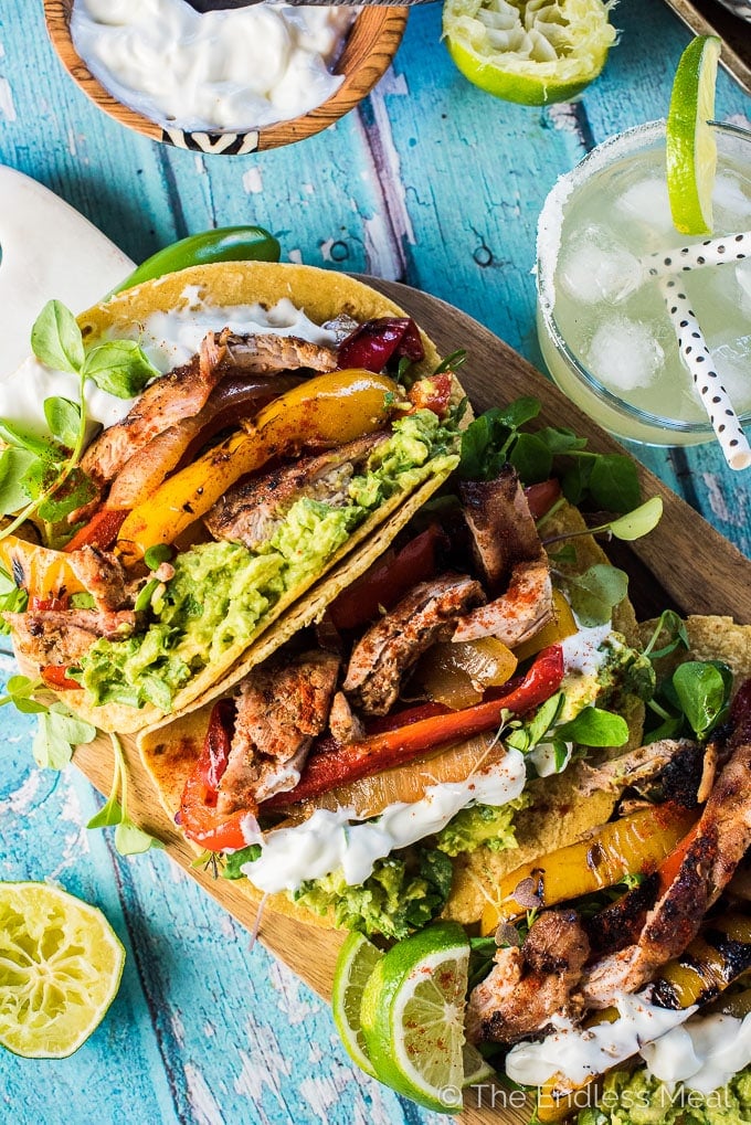 several grilled mezcal fajitas on a wooden cutting board