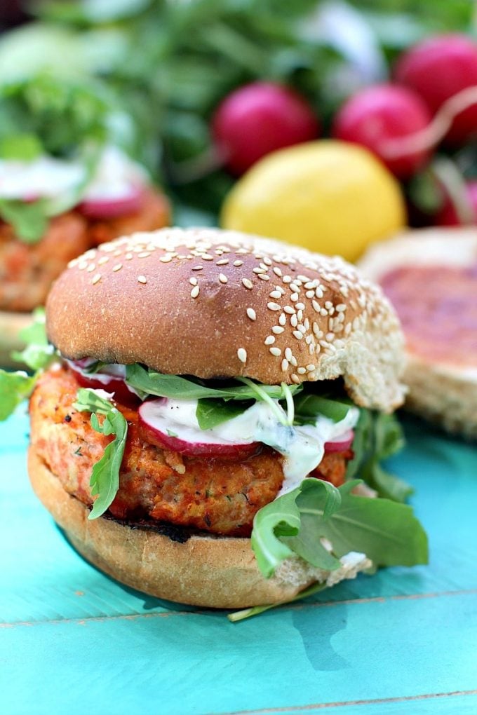 lemon dill spicy salmon burger on a sesame bun close-up