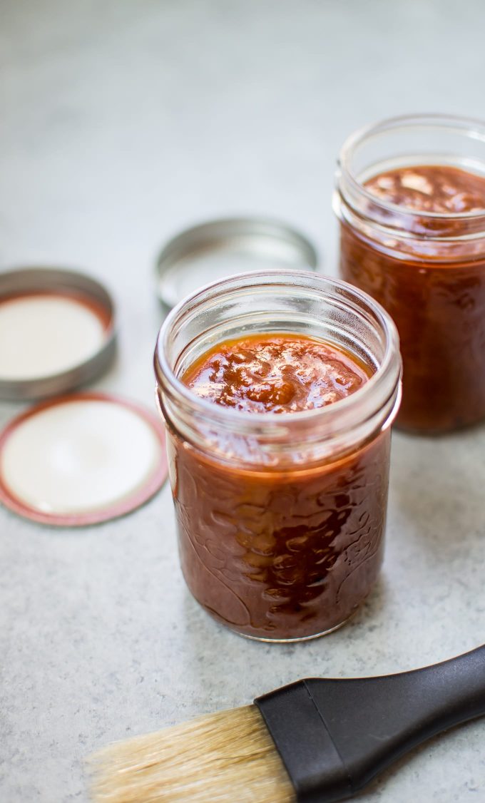 mason jars with apricot homemade barbecue sauce and basting brush