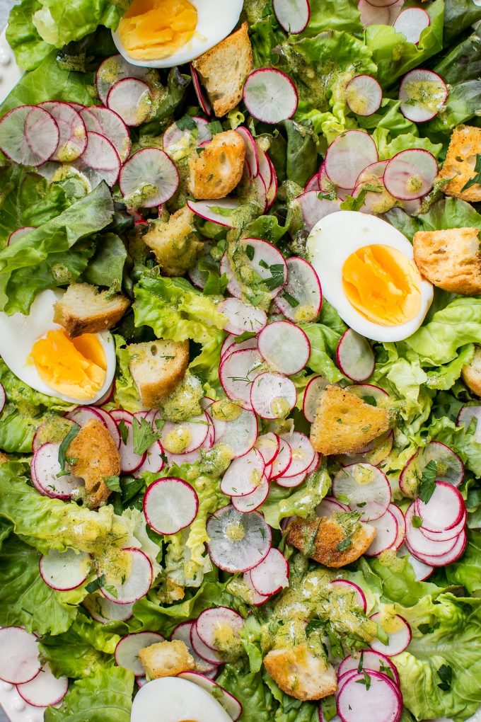 close-up of butter leaf salad with egg, radishes, and garlic croutons