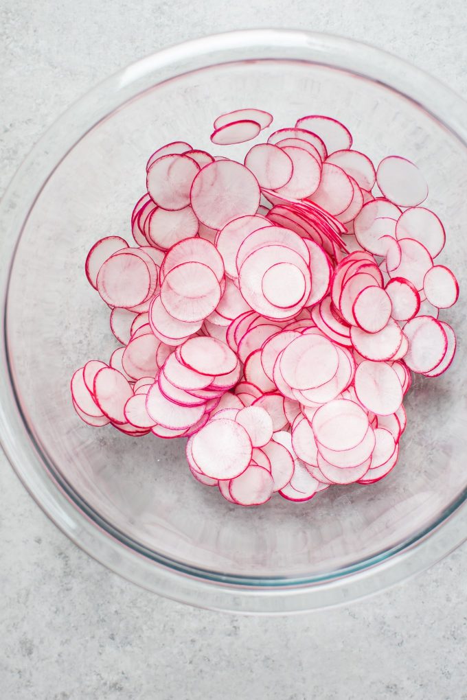 glass bowl with sliced radishes