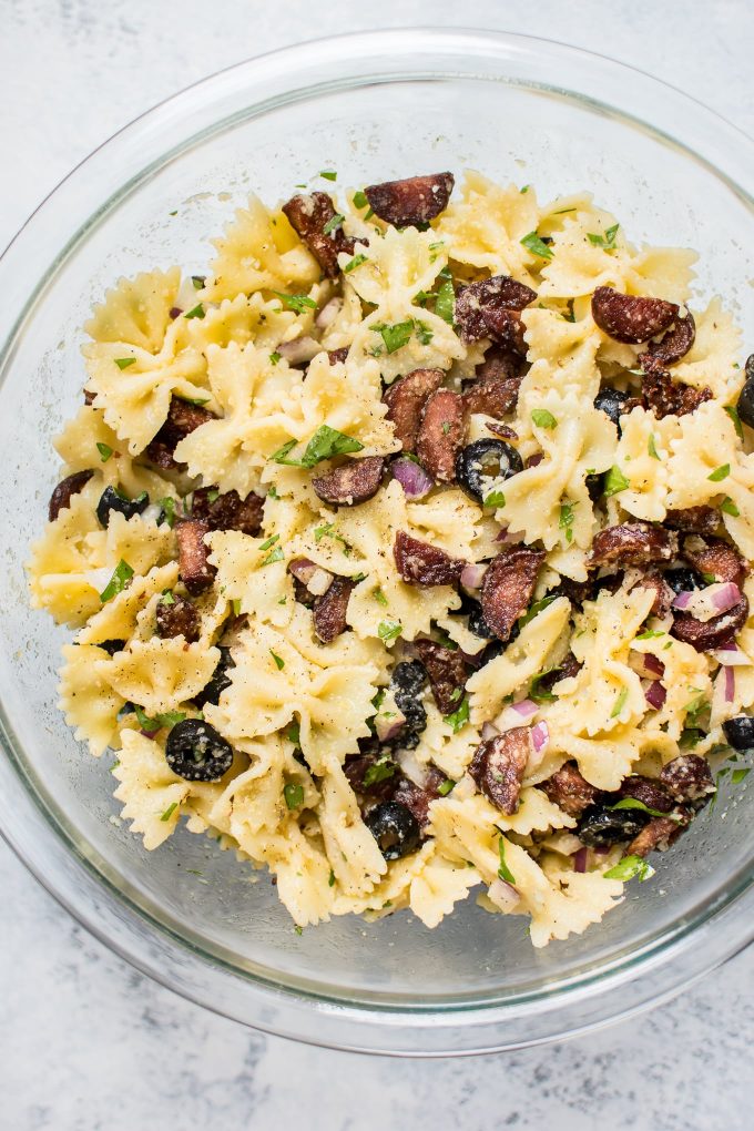 close-up of chorizo pasta salad in a glass bowl