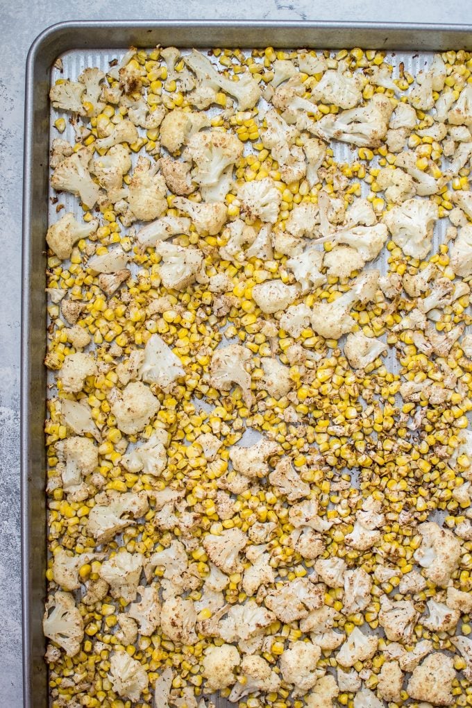 roasted corn and cauliflower on a baking sheet