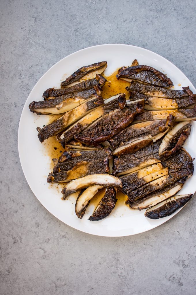 sliced grilled portobello mushrooms on a white plate