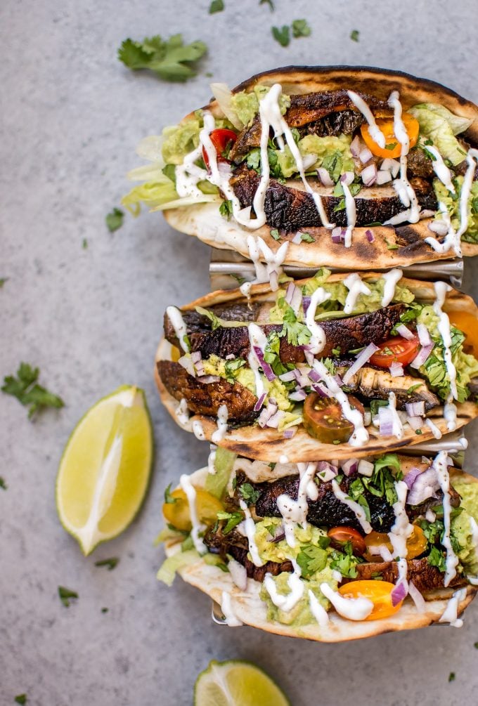 three healthy mushroom tacos and lime wedges