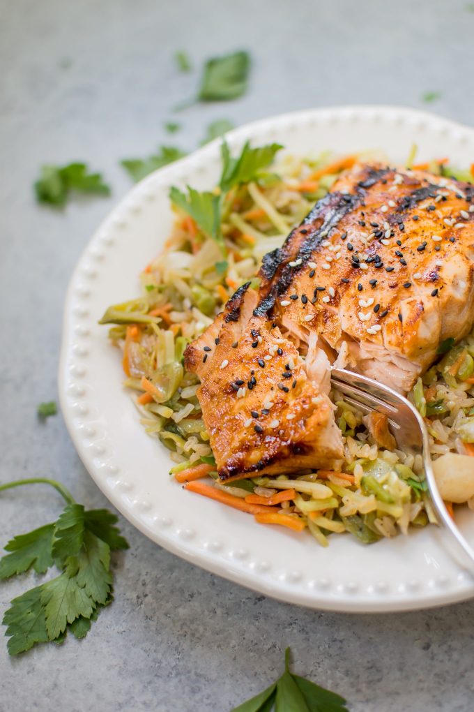 close-up of sesame sriracha grilled salmon nourish bowl with fork
