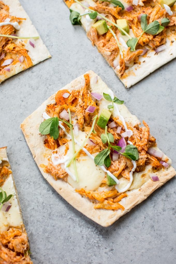 close-up of a slice of skinny buffalo chicken flatbread pizza
