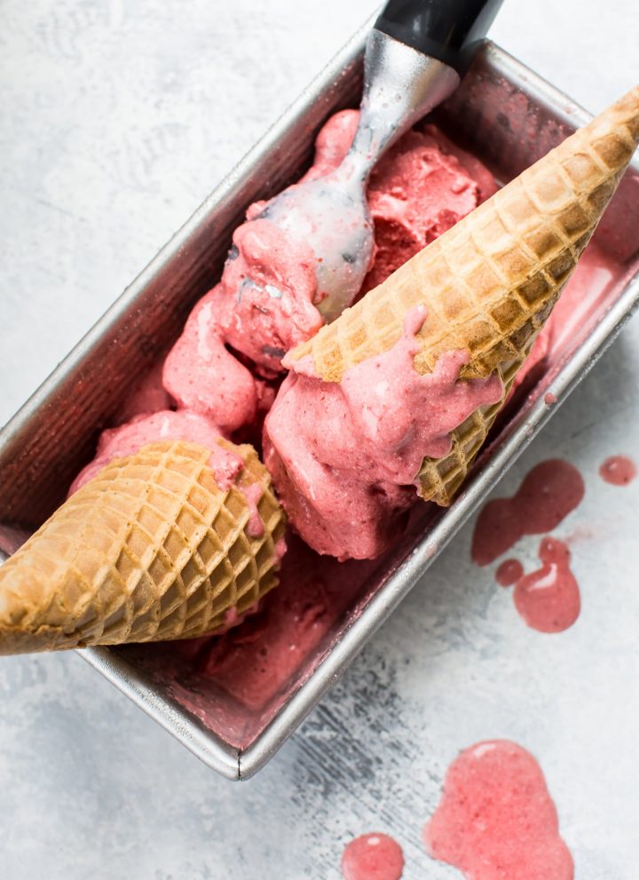 This 2-ingredient vegan strawberry ice cream is made with frozen strawberries, coconut milk, and your food processor in less than 10 minutes! 
