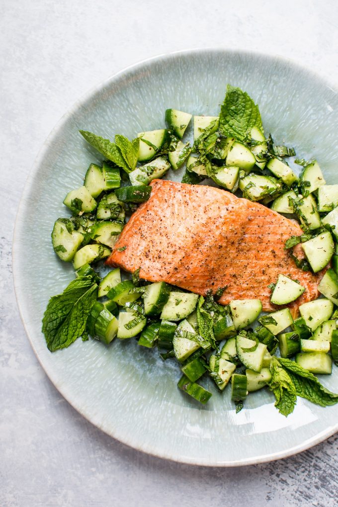 plate with healthy baked salmon and cucumber mint salsa