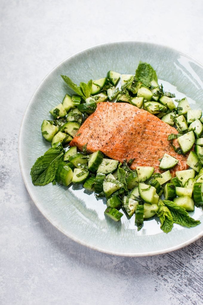 plate with baked salmon with mint cucumber salsa