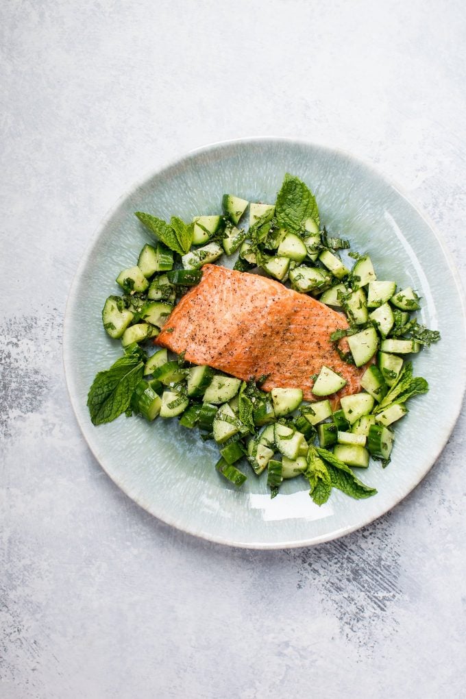teal plate with baked salmon and cucumber mint salsa