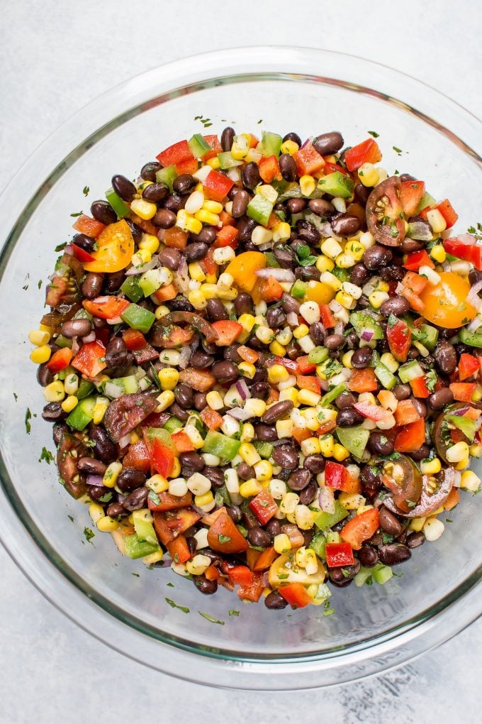 corn and black bean salad in a glass serving bowl