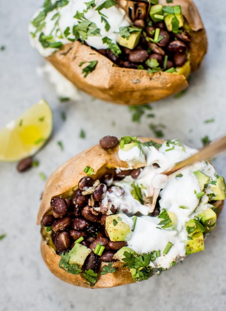 These healthy stuffed sweet potatoes make a fabulous light meal or side! Black beans with a quick lime dressing, Greek yogurt, avocado, and chives top these flavor-packed bundles of deliciousness.