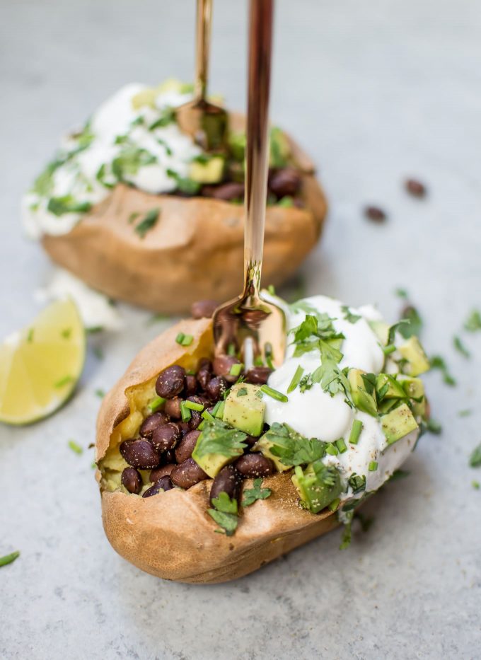 stuffed healthy sweet potato with a fork