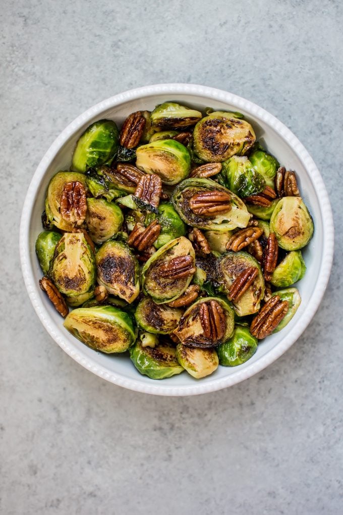 sweet and savory maple pecan Brussels sprouts in a white bowl