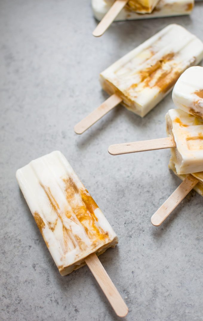 several healthy pumpkin breakfast popsicles on a flat surface