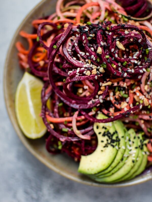 This rainbow noodle salad is a healthy, fun, and colorful dish that's made entirely of vegetable noodles. A creamy avocado-lime dressing makes it extra flavorful!