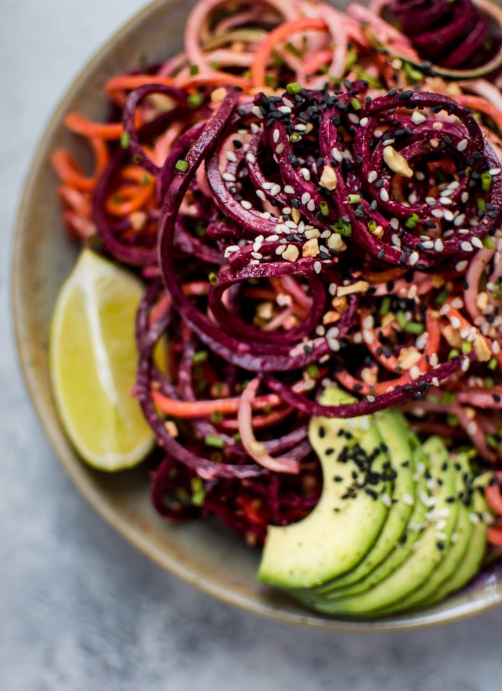 This rainbow noodle salad is a healthy, fun, and colorful dish that's made entirely of vegetable noodles. A creamy avocado-lime dressing makes it extra flavorful!