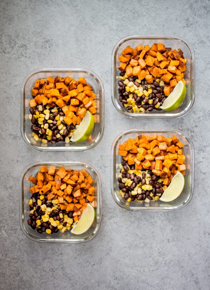 several glass containers with vegan southwest sweet potato meal prep bowls